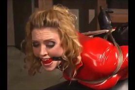 MILF in red catsuit hogtied and feet spank