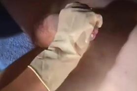 Nurse in latex gloves gives a handjob