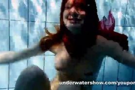 Redhead Mia stripping underwater