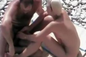 Nudist handjob at rocky beach