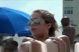 Topless beach girl with massive boobs
