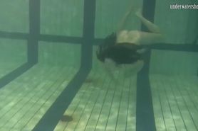 Dressed up teen Irina Barna swims sexy in the pool