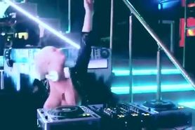 Nude DJ playing music with her boobs bouncing