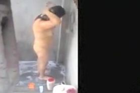 Woman filmed in secret while bathing in a outdoor scene
