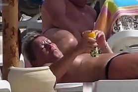 Milf topless woman creams on the beach