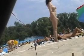 Nudist beach voyeur vid with a hot brunette milf