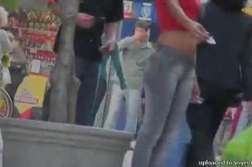 candid petite tanned ad girl standing on the street in tight clothes
