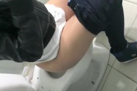Girl cleans the toilet seat and pees