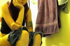 Colorful hair teen pees in bathroom