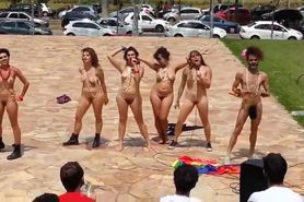 Naked singing and dancing girls put on a public show