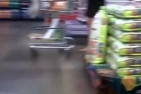 Exhibitionist woman in flip flops flashing in supermarket