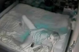 Hidden cam catches mother fingering on bed.