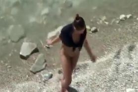 Nudist woman spied in rocky beach