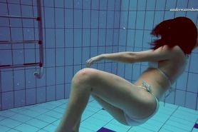 Clothes coming off underwater in swimming pool of Alla