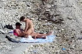 Sensual girl jumps on her boyfriend's fat cock at the nude beach