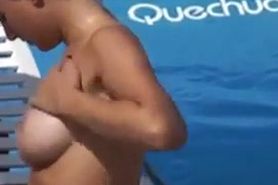 Beauty putting sunscreen on her mounds 1