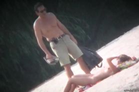 Spy cam shot of a hot nudist blond tanning on the beach