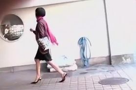 Asian girl unlocking her bike gets a skirt sharking.