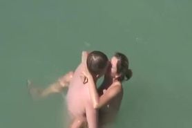 Beach couple sex in the sea