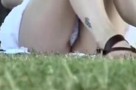 Girl shows polka dot panty upskirt on the green lawn AE25