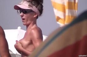 Very horny milf rubbing tits in nude beach
