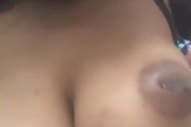Big titted black slut sucking her own nipples