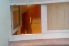 Guy made a window peep vid with a chick stripping