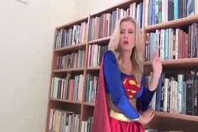 Supergirl defeated by a villianess  wearing a latex bikini,skirt & mask