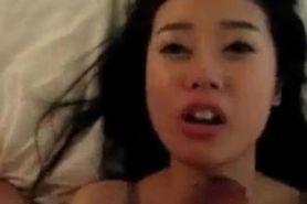 Cute Asian gf sucking and licking on a white hard cock