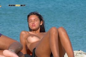 A young hot nudist girl with sexy ass at the nudist beach