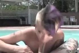 Tattooed punk shaved girl blowing near pool