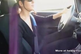 Nice looking woman gives handjob while driving