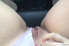 Horny girl fingering her cunt in the car