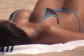 Tan busty asian in beach voyeur video