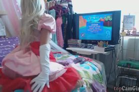 Sexy princess cosplayer playing her video game