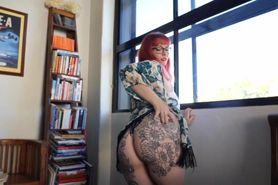 Thicc redhead shakes tattooed ass in thong