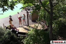 Slutty girlfriends get fucked outdoors by the lake