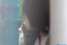 Shy Japanese trick playing with her phone during sharking attack