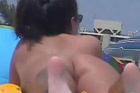 Naked hotties followed around by a nude beach voyeur
