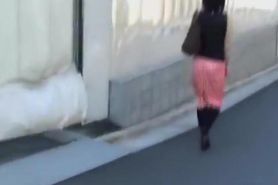 Japanese sharking video showing a chick in a red skirt