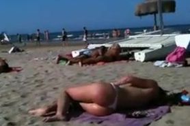 Flawless topless blond butt on the beach