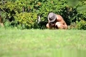 Peeing in the bushes in the meadow