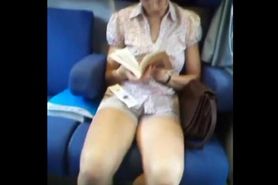 girl very nice in shorts reading in train
