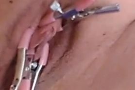 Pussy clinching  on benwa balls with clamps on