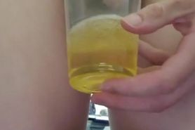 Sissy drinking own piss from cup.
