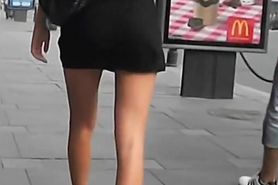 Hot tanned brunette chick walks on a busy street sidewalk upskirt