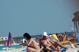 Mature nudist lady puts lotion on herself