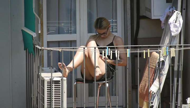 Candid blonde girl showing her feet on the balcony TNAFlix Porn Videos photo